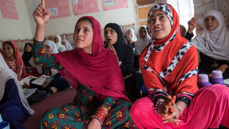 Marzia (left), 12, and a classmate during a lesson